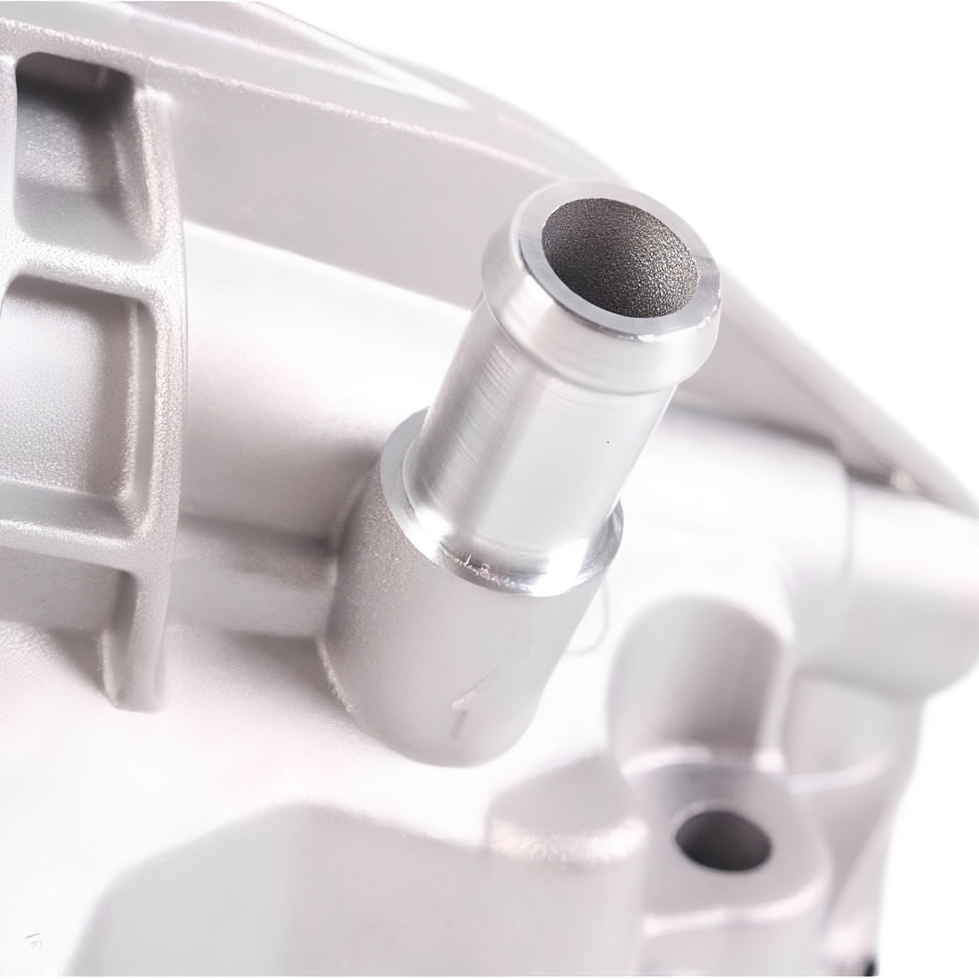 Oil filter housing close-up of silver threaded inlet port