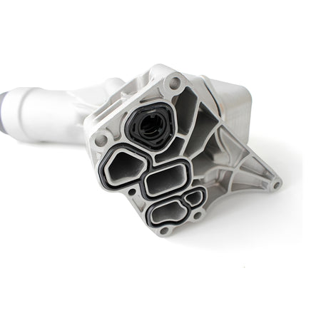 Aluminum oil filter housing with black connector ports and gasket seals