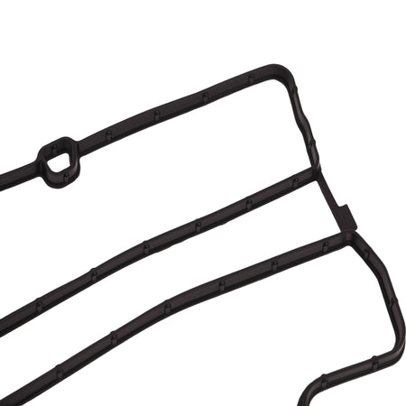 Valve cover gasket seal with molded mounting tabs and channel ridges